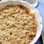 Rhubarb crumble in a dish with serving spoon.
