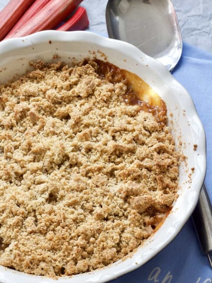 Rhubarb crumble in a dish with serving spoon.