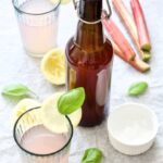 Bottle with rhubarb cordial & glasses.