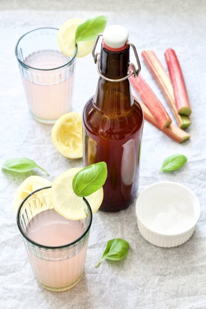 Bottle with rhubarb cordial & glasses.