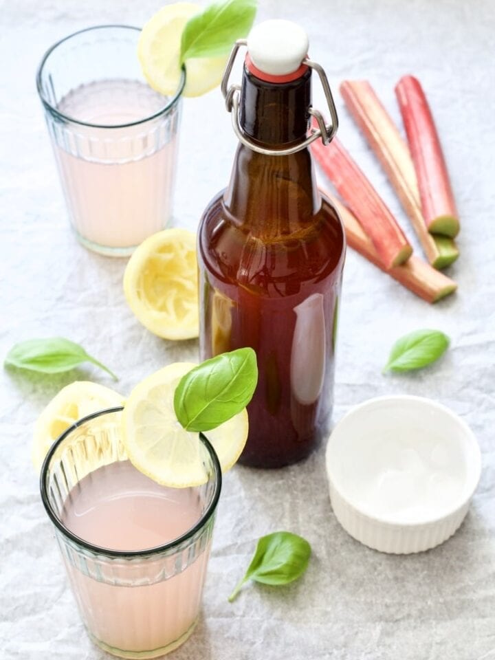 Bottle with rhubarb cordial & glasses.