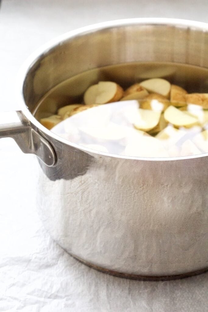 Potatoes in a pan of water.