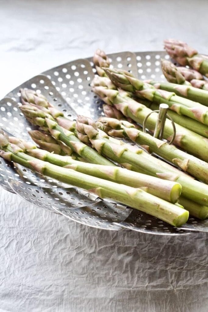 Asparagus in a steaming basket.