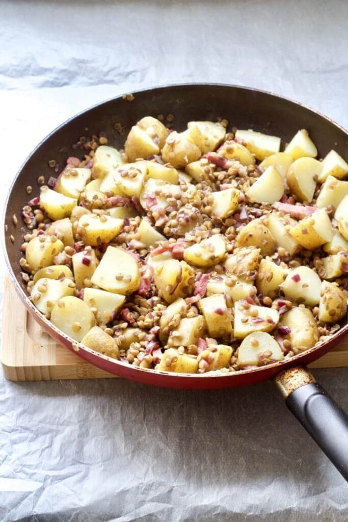 Potatoes and lentils in a pan.