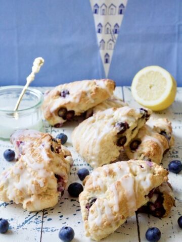 Blueberry scones with lemon glaze on the board.
