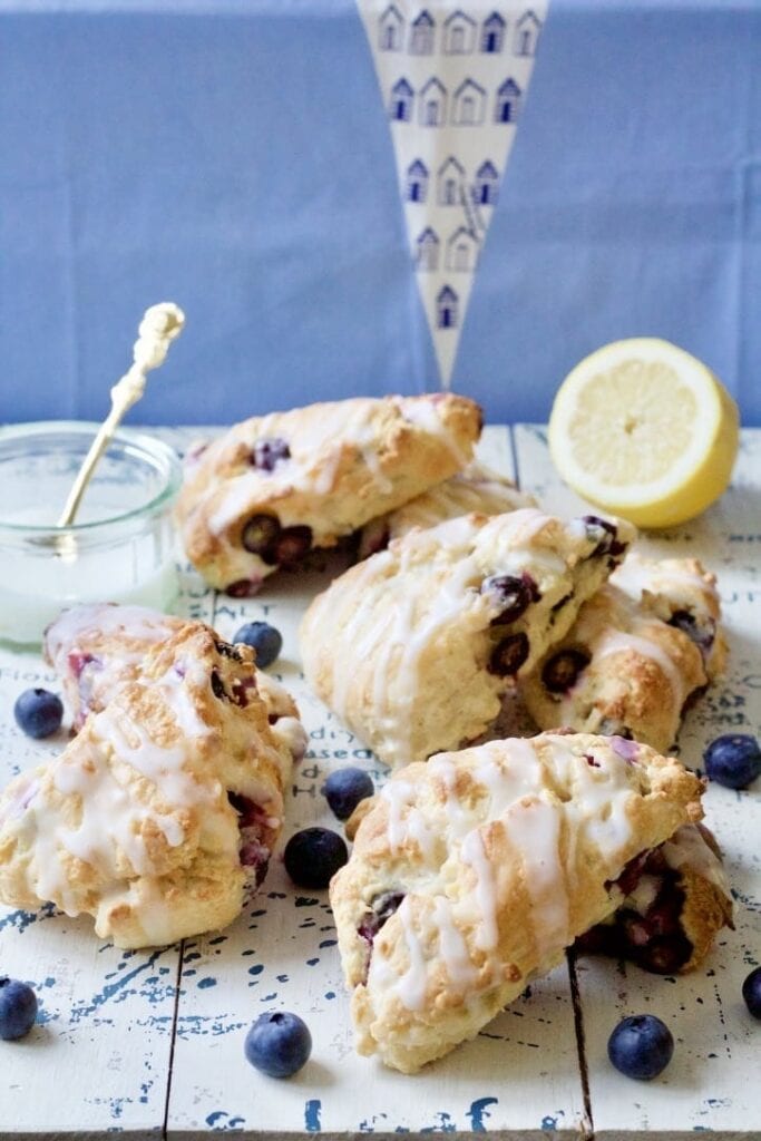 Blueberry scones with lemon glaze on the board.