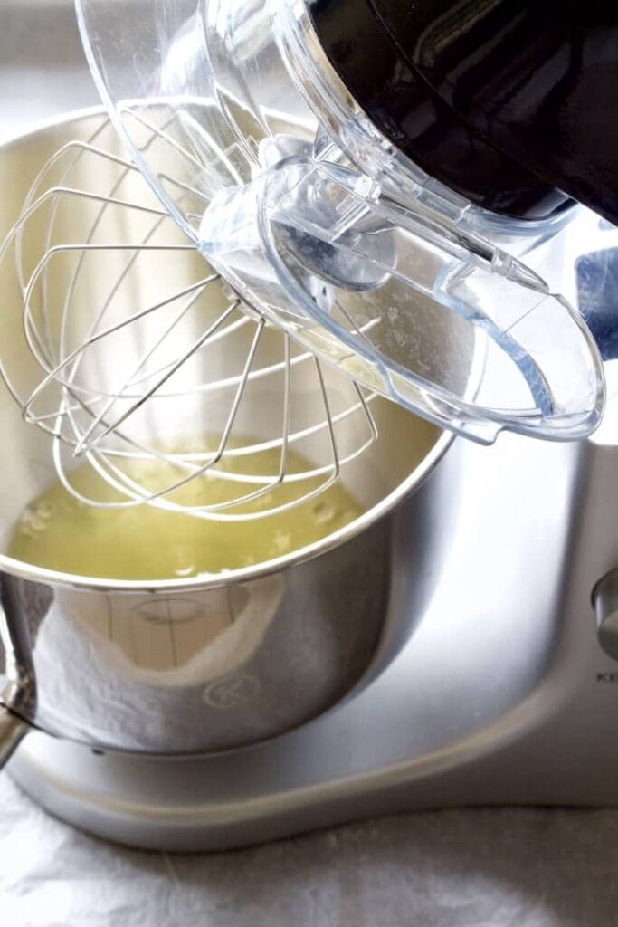 Egg whites in a bowl of standing mixer.