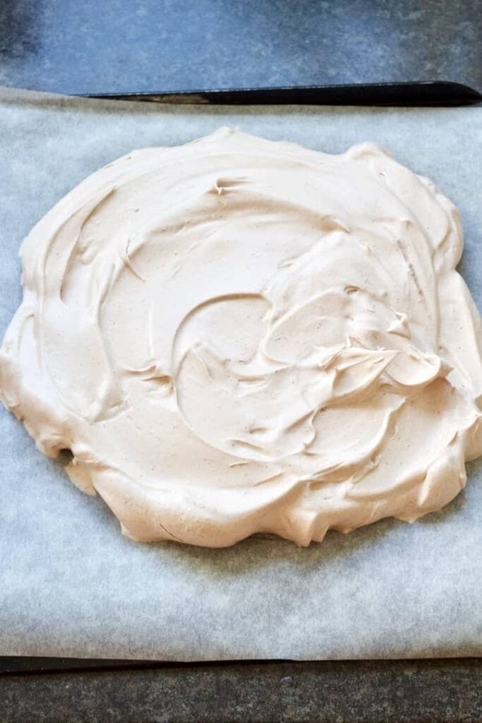 Chocolate pavlova on a baking tray ready for the oven.