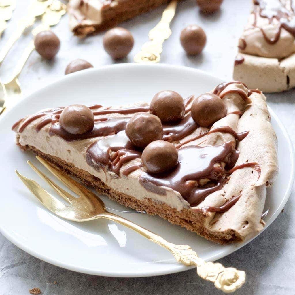 Slice of chocolate pavlova on a plate with a fork.