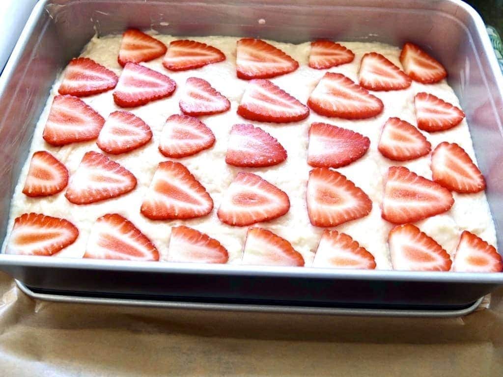 Strawberry cake in a tin ready for the oven.