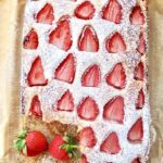 Strawberry Cake with one slice missing.
