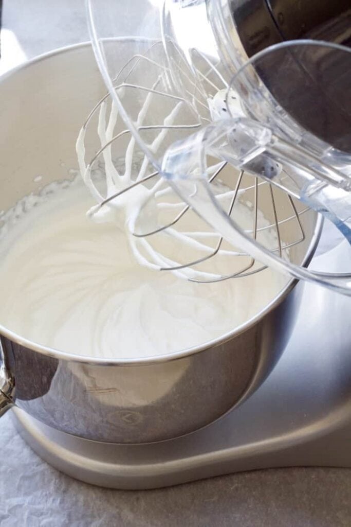 Open food processor with mixture in a bowl.