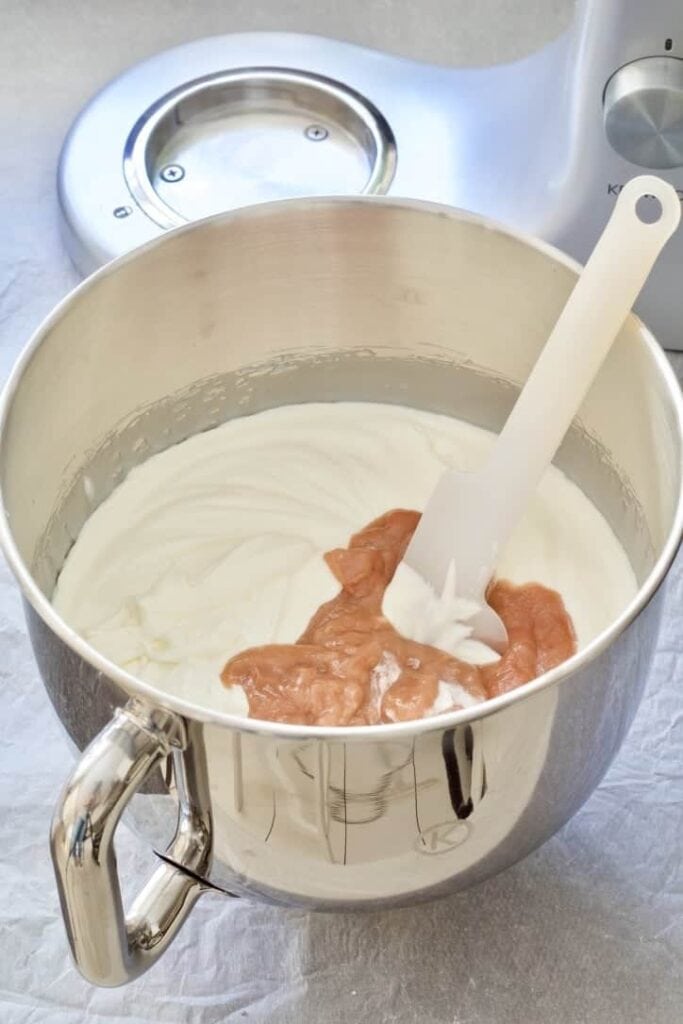 Ice cream mixture with rhubarb puree in a bowl.