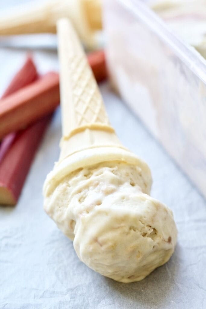 Ice cream in a cone laying down.