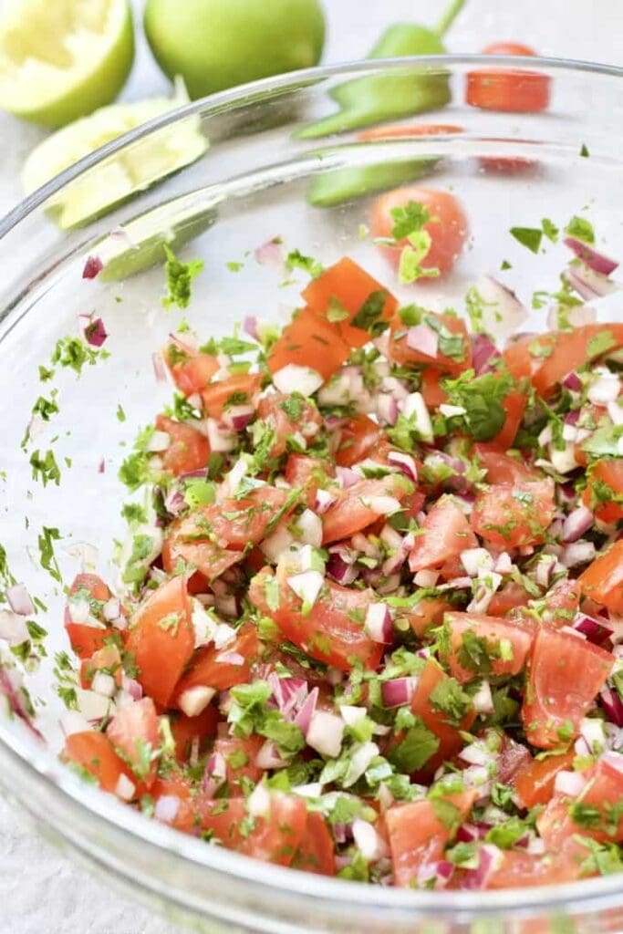 Fresh tomato salsa in a large glass bowl.