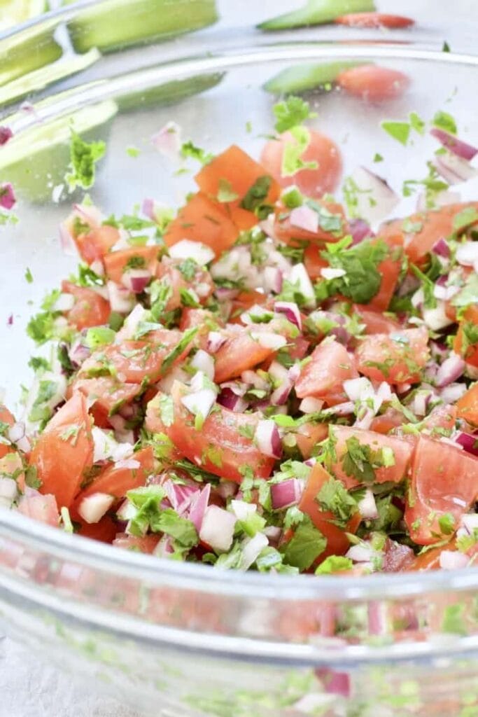 Fresh tomato salsa in a large glass bowl.