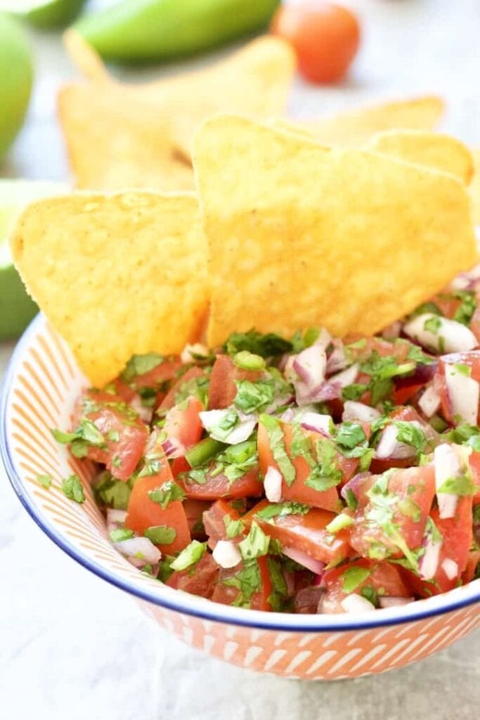 Tomato salsa in a bowl with tortilla chips.