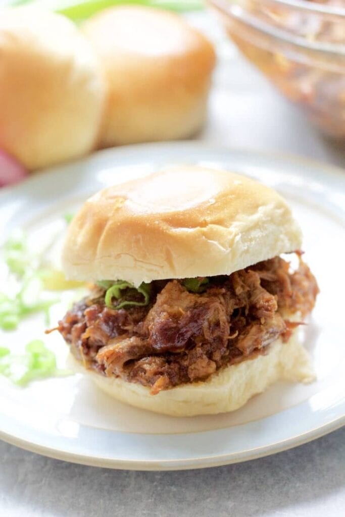 BBQ pulle pork in a bun on a plate.