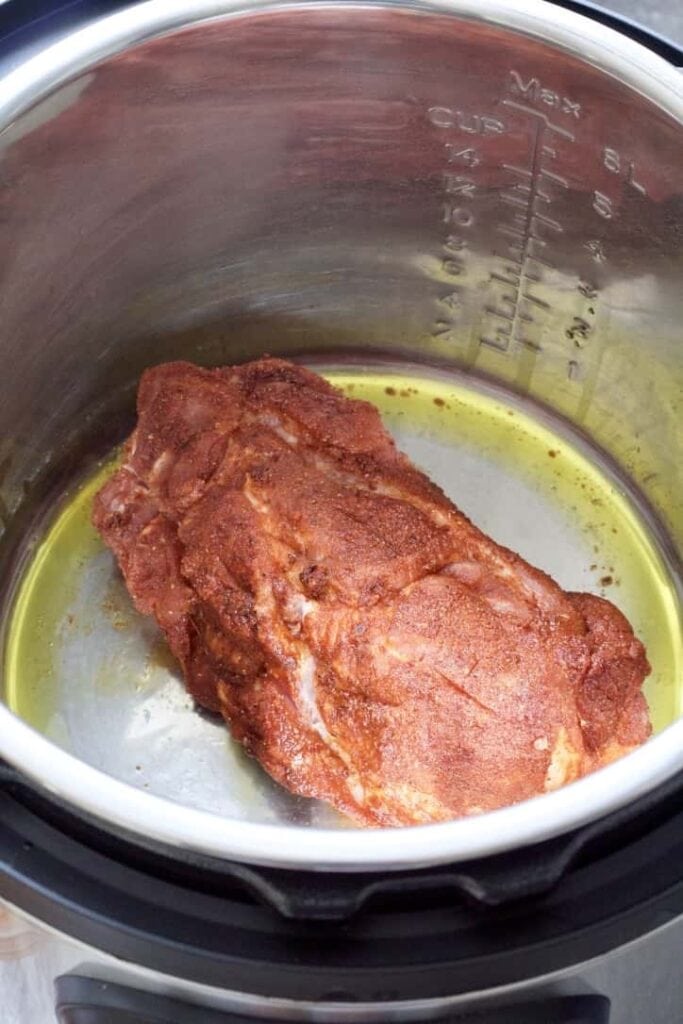 Pork shoulder frying in the Instant Pot.