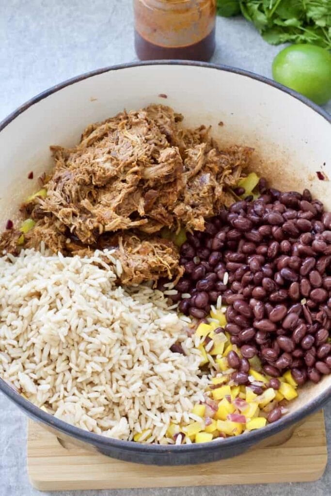 Rice, meat, beans & pepper in a pan.