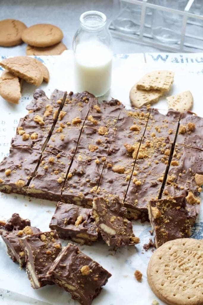 Rocky Road cut into portions, bottle of milk and biscuits.