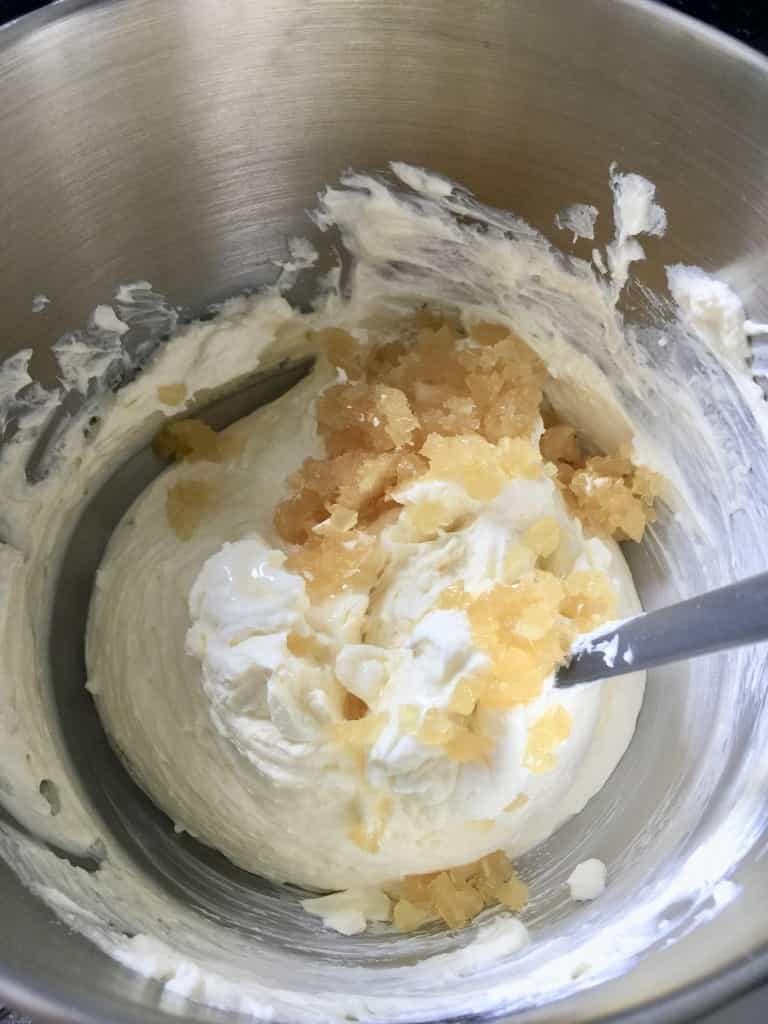 Stem ginger being mixed with cream cheese.