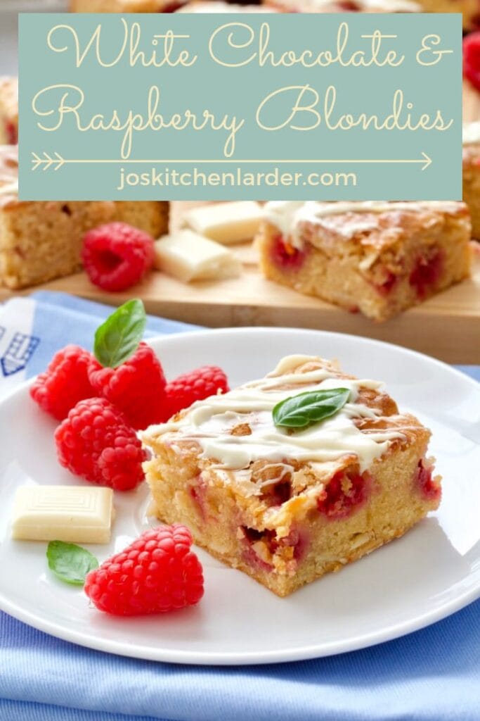 Blondie square on a plate with fresh raspberries.