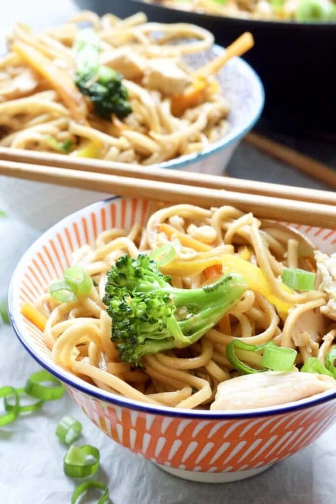 Chicken Chow Mein in a bowl close up with broccoli on top.