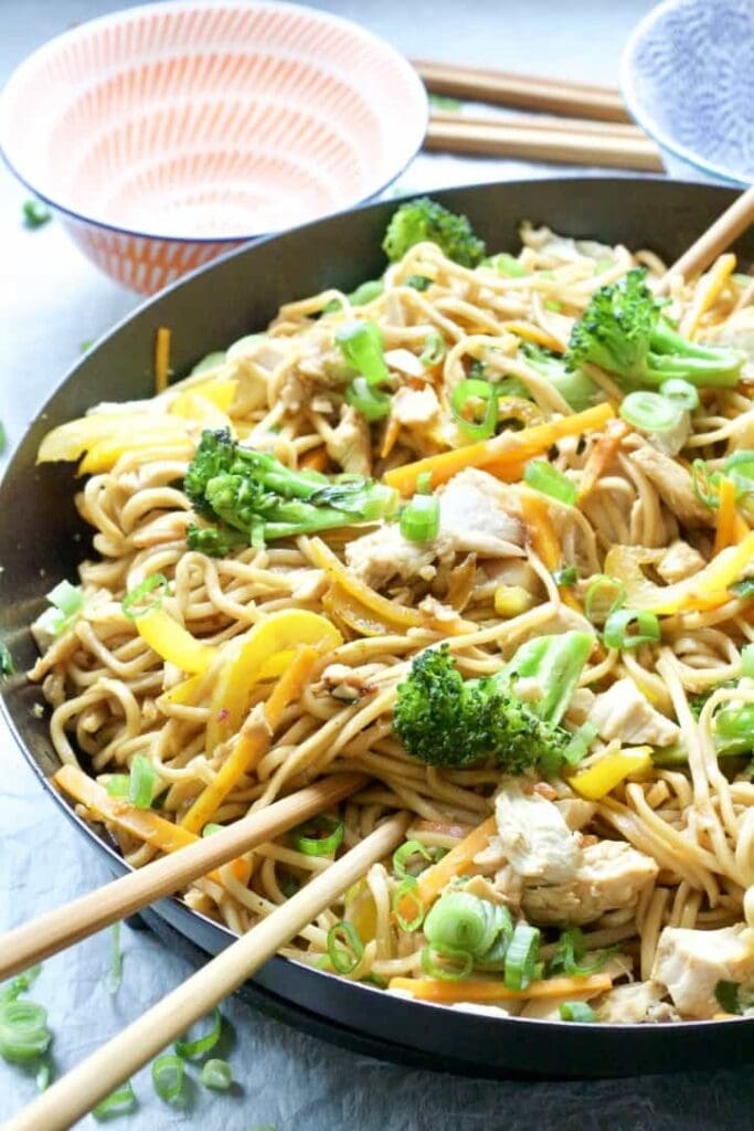 Chicken Chow Mein in a pan with chopsticks.