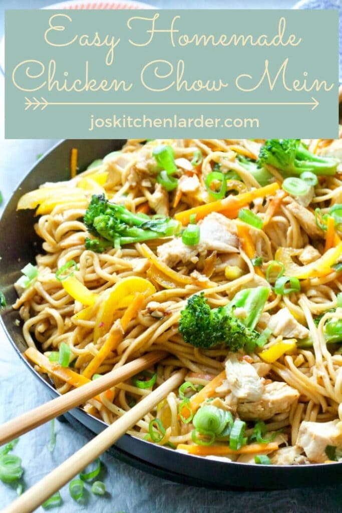 Chicken chow mein in a pan with chopsticks.