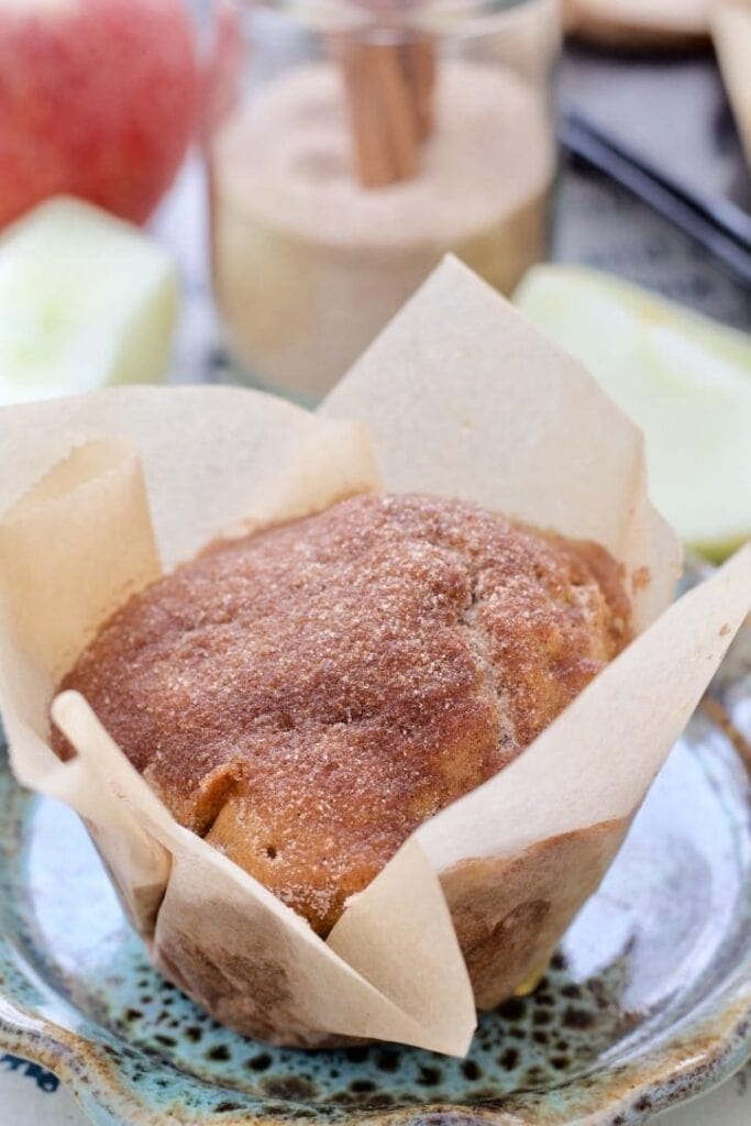 Apple & cinnamon muffin wrapped in paper.