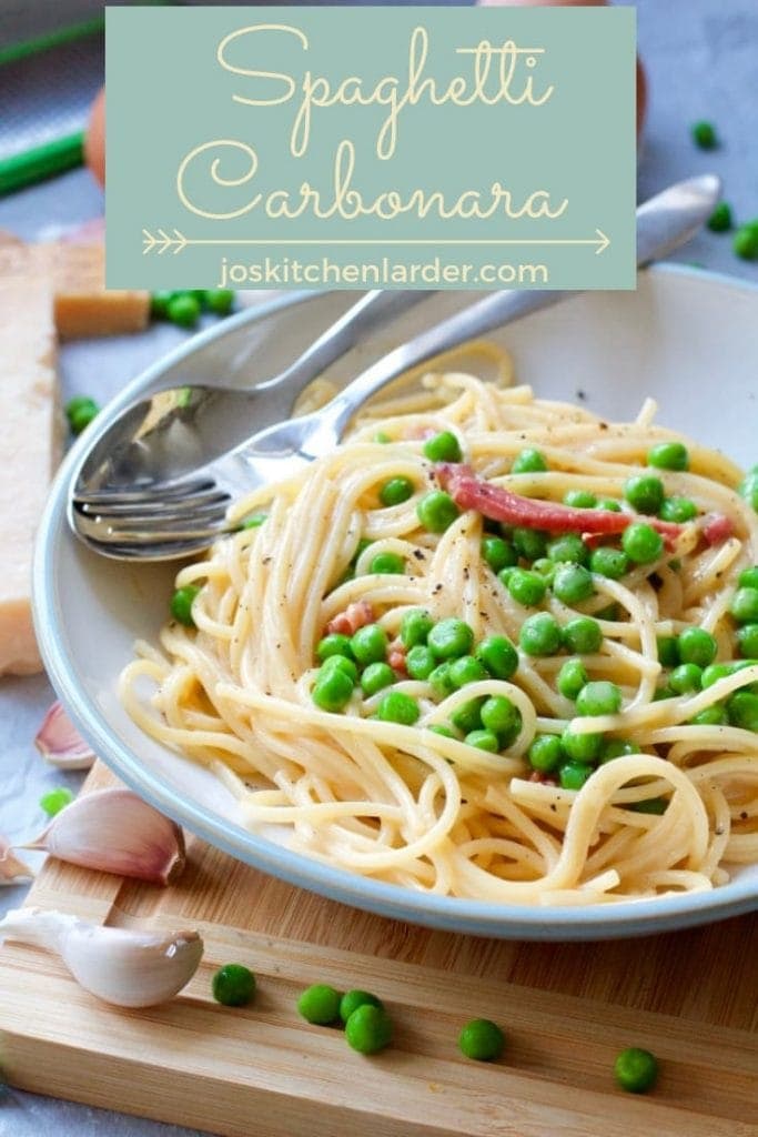 Spaghetti carbonara plated up with cutlery.