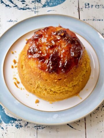 Whole pumpkin steamed sponge pudding on a plate.