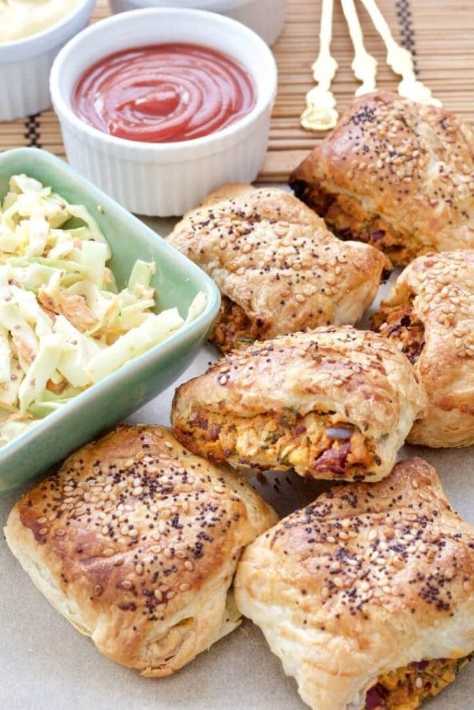 Sausage rolls with side of coleslaw and ketchup.