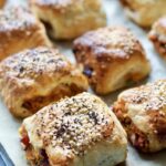 Close up of a veggie sausage roll on a baking tray.