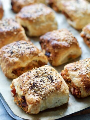 Close up of a veggie sausage roll on a baking tray.