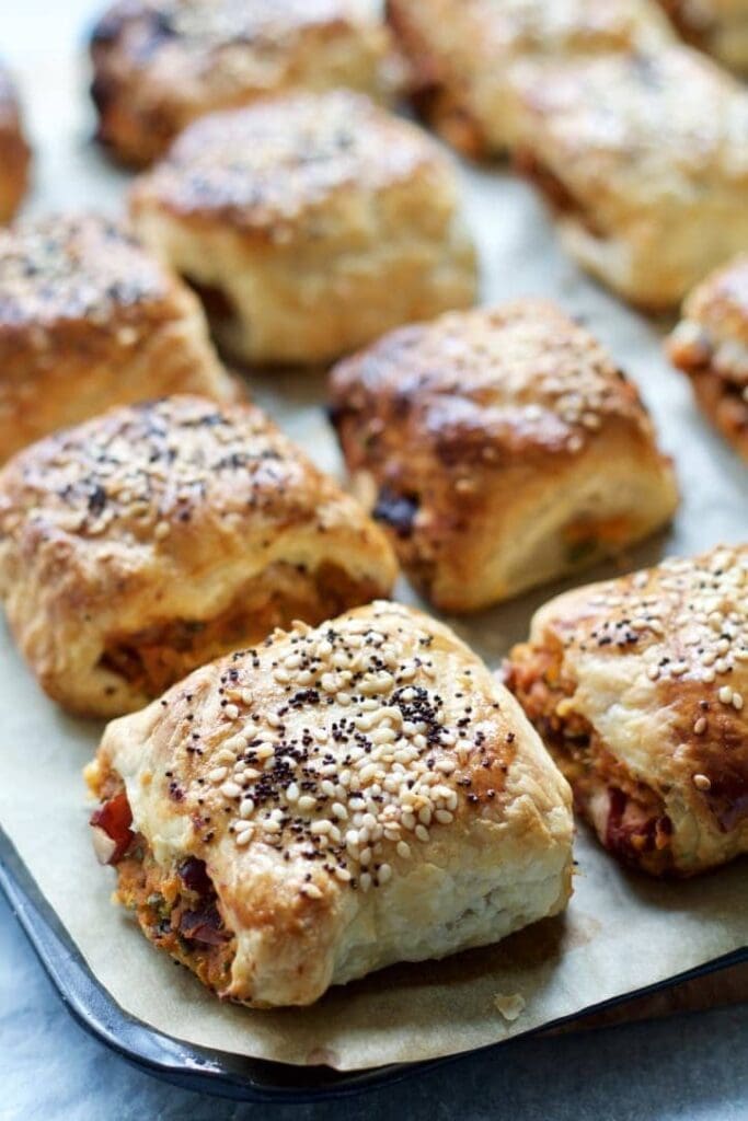 Close up of a veggie sausage roll on a baking tray.