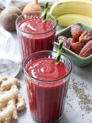 Close up of smoothie in a glass with a straw.