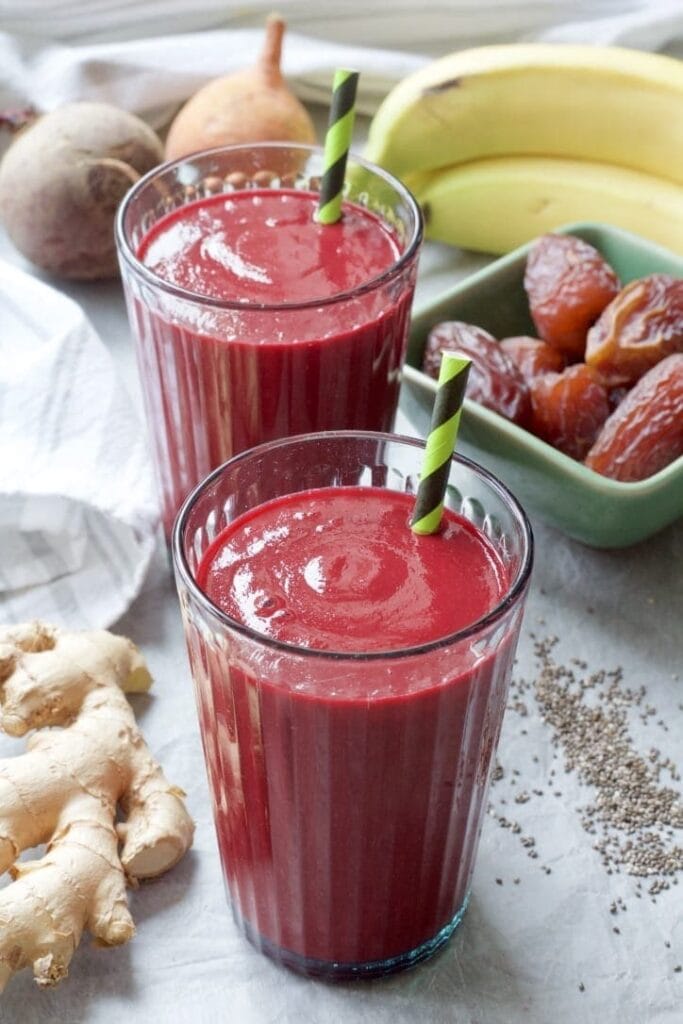 Close up of smoothie in a glass with a straw.