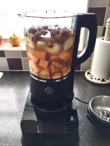 Ingredients for soup in a blender with added stock.