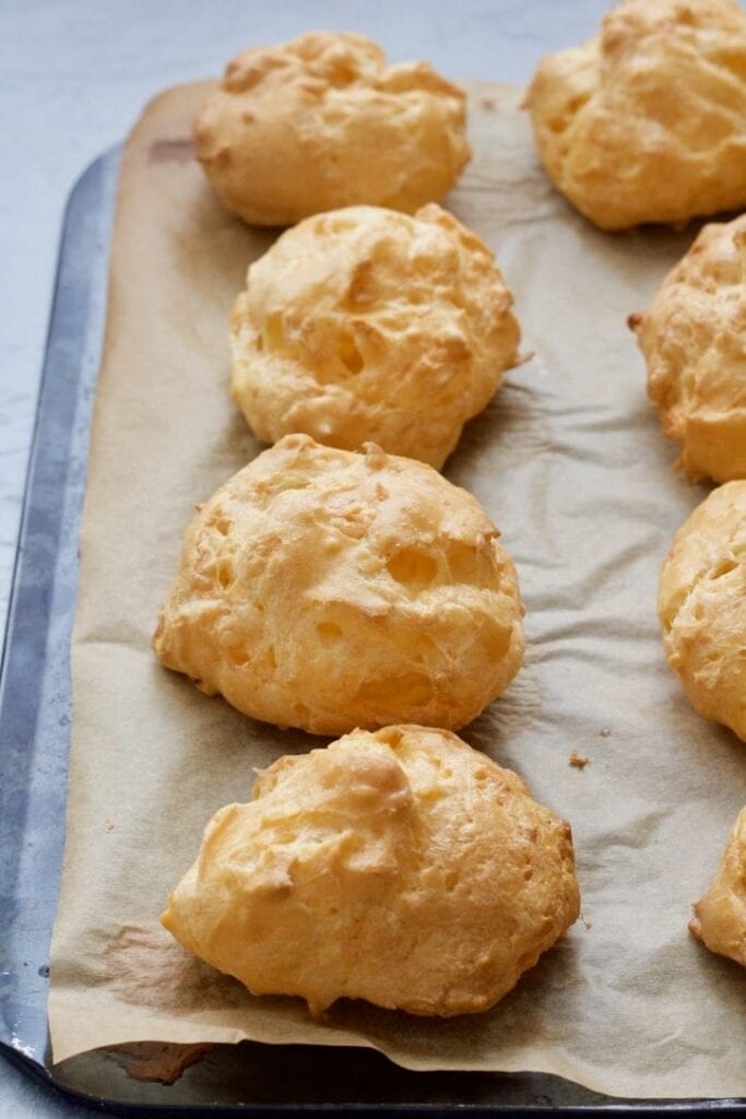 Baked cheese puffs on a tray.