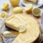 Cheesecake topped with lemon curd and lemon slices.