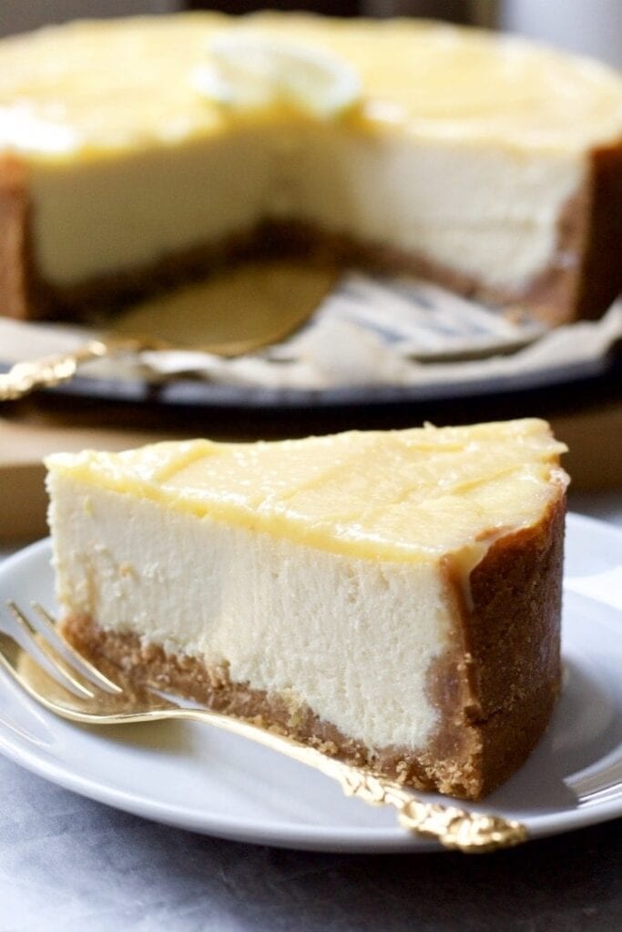 Slice of cheesecake on a plate with a fork.
