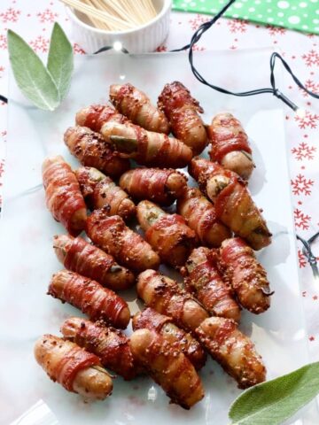 Cocktail sausages wrapped in bacon on a platter.