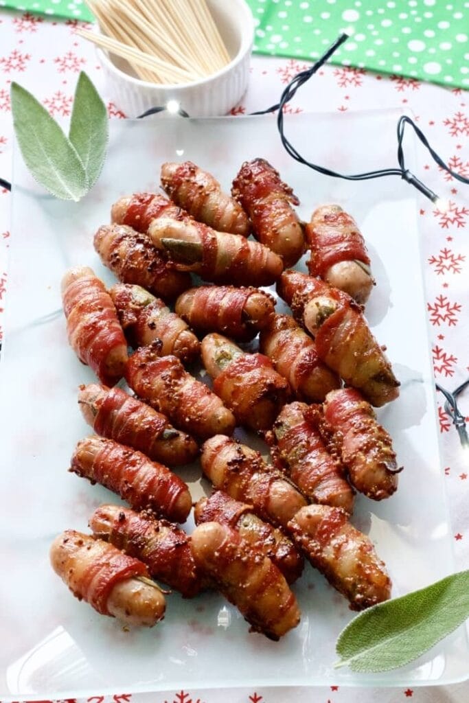 Cocktail sausages wrapped in bacon on a platter.