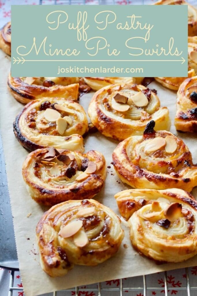 Baked swirls topped with almond flakes on a tray.