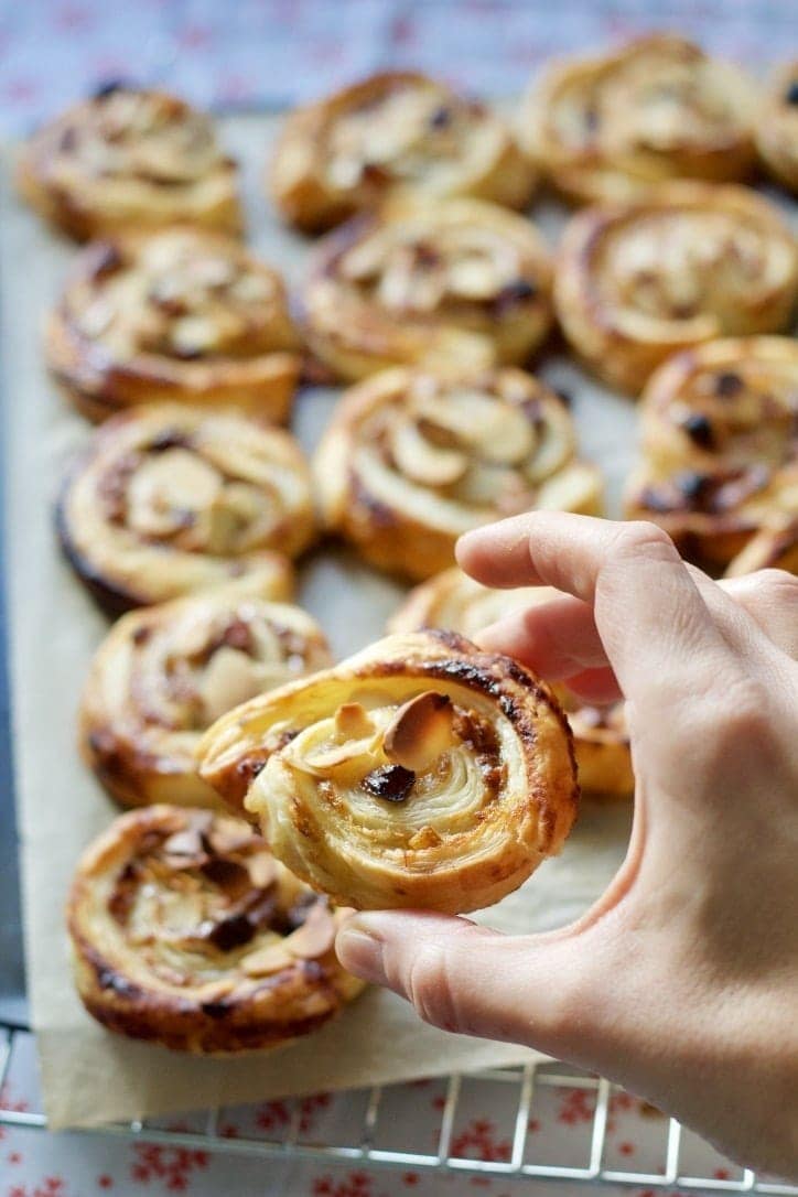 Hand holding puff pastry mince pie swirl.