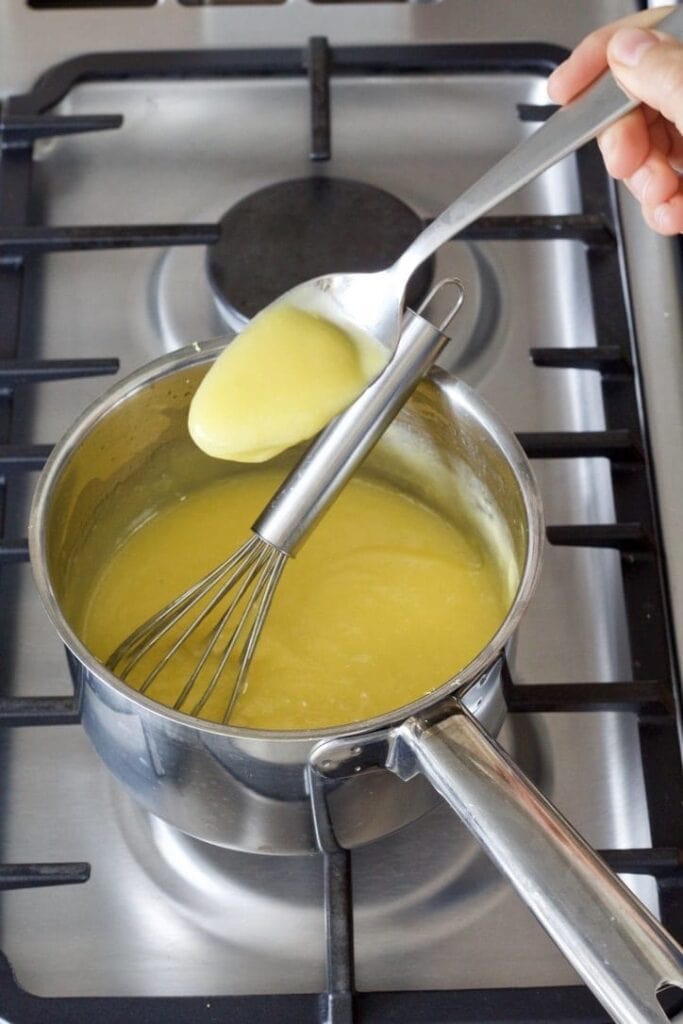Checking whether lemon curd is ready.