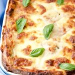 Lentil and Spinach Lasagne in a dish with basil leaves.