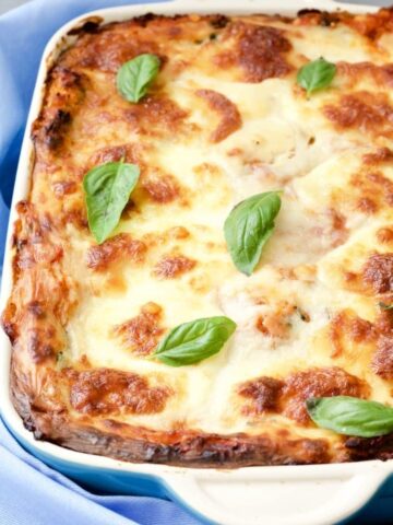 Lentil and Spinach Lasagne in a dish with basil leaves.